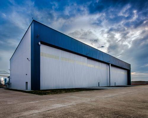 Exterior of MAAS Aviation Painting Facility. Hangar door shut.