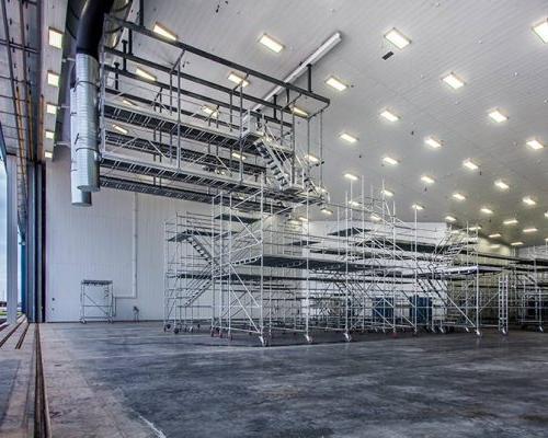 Interior of MAAS Aviation Facility hangar. Large open space with metal painting equipment.